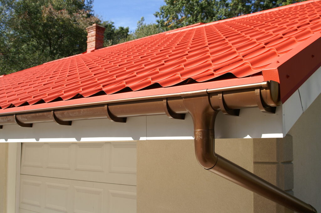 a corner of a house with gutters and metal roof